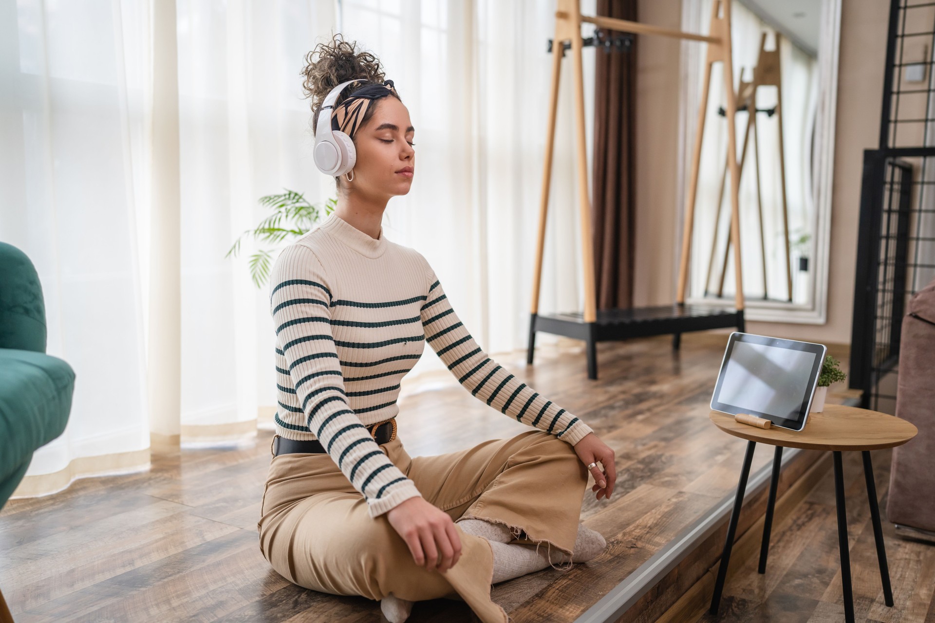 one woman doing guided meditation yoga self care practice at home